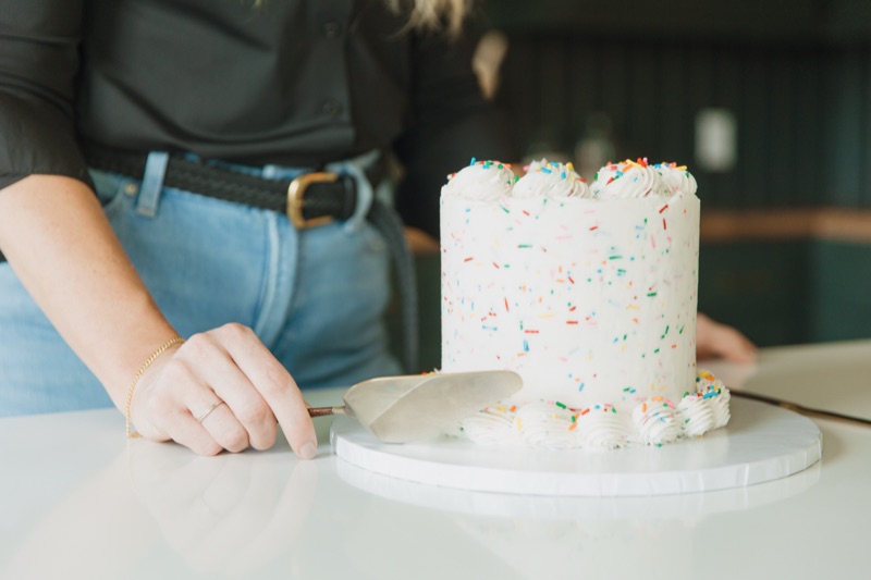 Slicing a funfetti layer cake