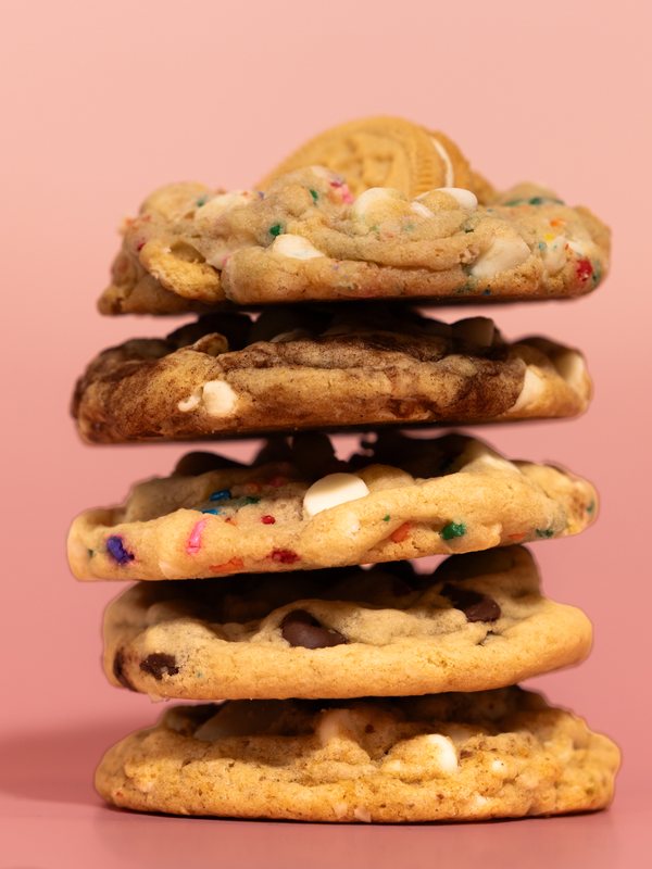 A stack of five cookies loaded with sprinkles, white chocolate and chocolate chips